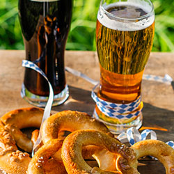 LaramieBrewfest Image of beer in glasses a pretzels during Laramie Brewfest